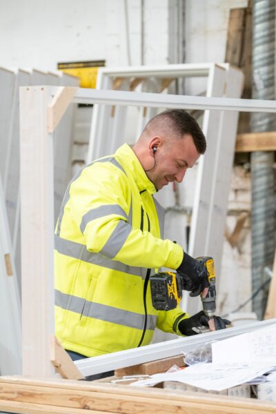 A man constructing a door frame for Donaldson Door Systems